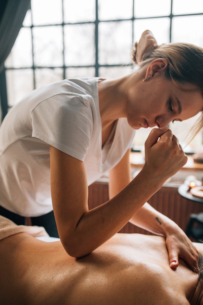 A relaxing massage therapy session indoors with a focus on body care and self-care.